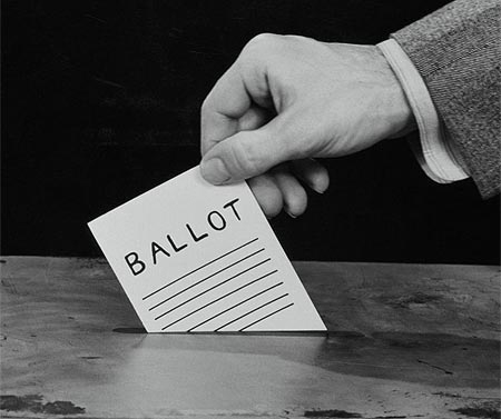 Photo of placing ballot into a ballot box