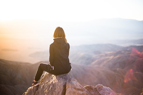 Photo of a woman sitting on a rock